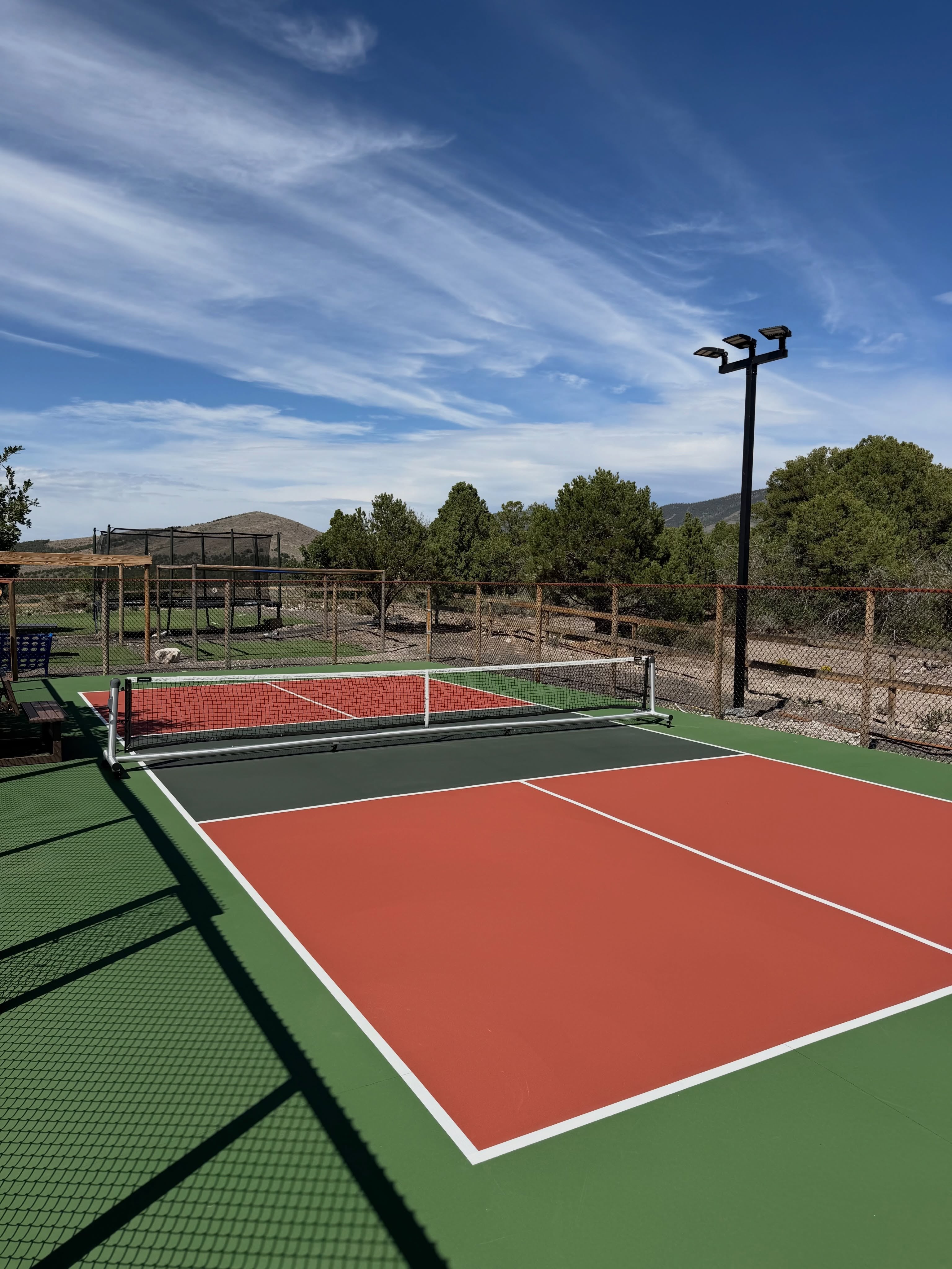 Outdoor pickleball court with a Dominator net