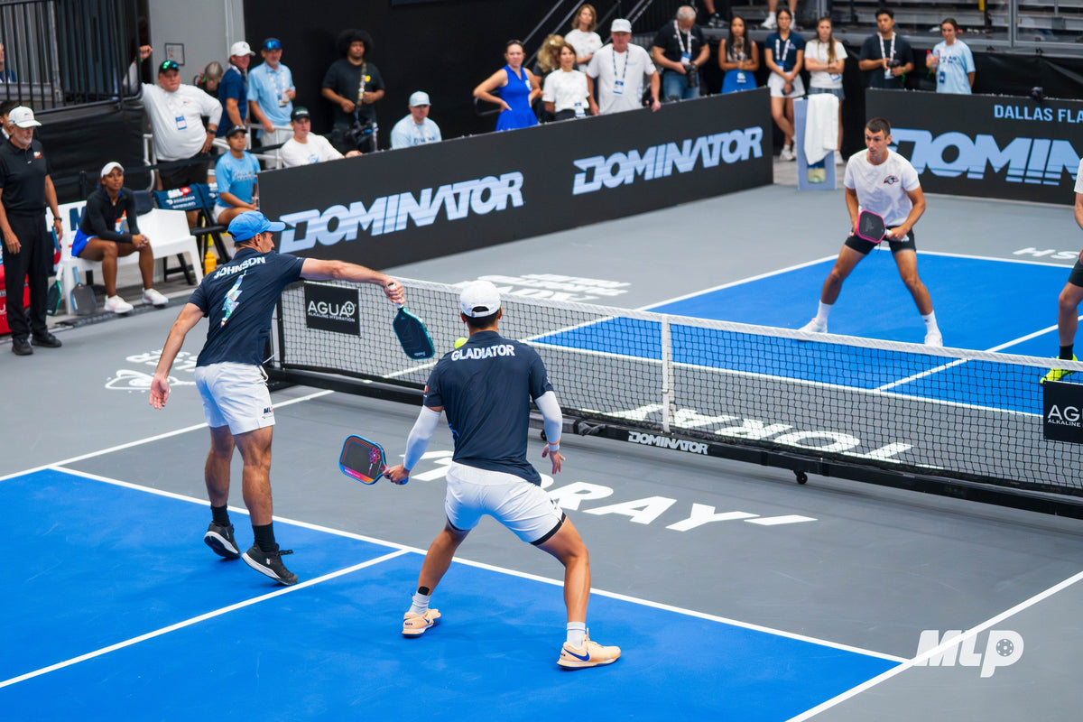 Doubles match at MLP Dallas with a Dominator Pro Max net and Dominator courtside branding